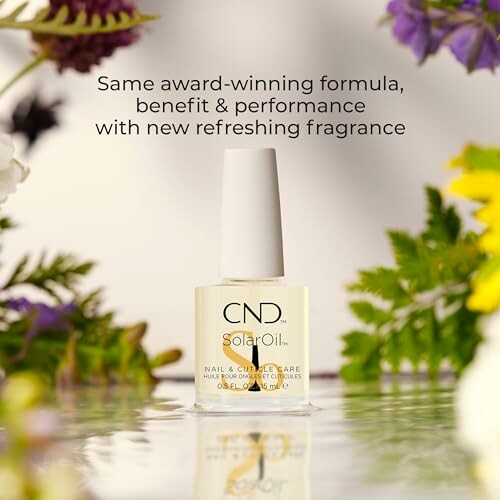 Hand holding CND SolarOil with ingredients