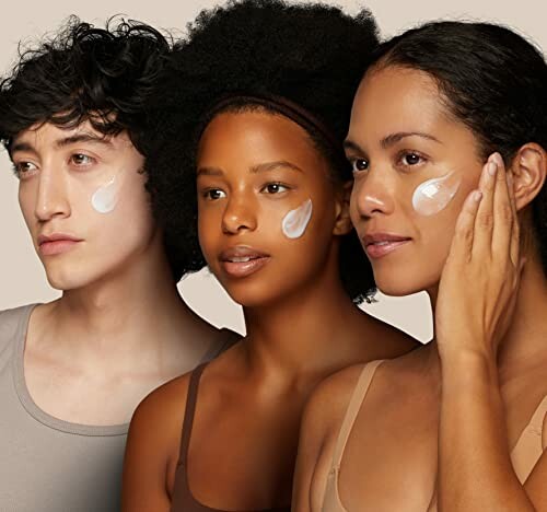 Three people with skincare cream on cheeks.