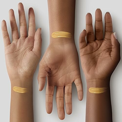 Three hands with foundation swatches on different skin tones