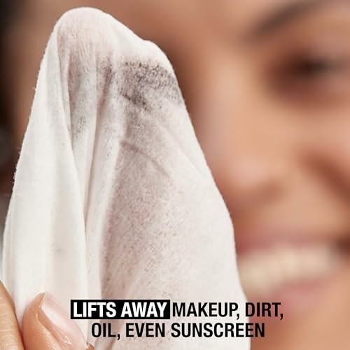 Close-up of a makeup removal wipe lifting away makeup and dirt