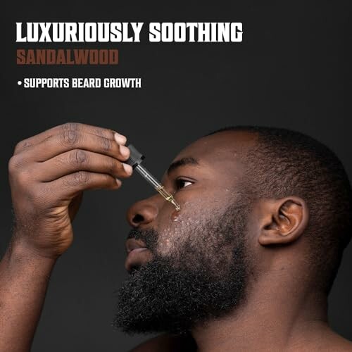 Man applying sandalwood beard oil with dropper.